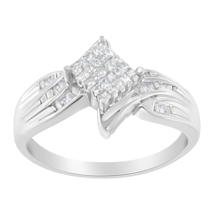White metal ring shown at an angled top view, featuring a square cluster of white gemstones in prong setting at the center, flanked by channel-set baguette-shaped white gemstones on the split band.