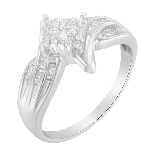 White metal ring shown in a three-quarter angle with a square cluster of small white gemstones in the center, accented by baguette-shaped white gemstones in channel settings on the shoulders and princess-shaped white gemstones in invisible settings around the central cluster.