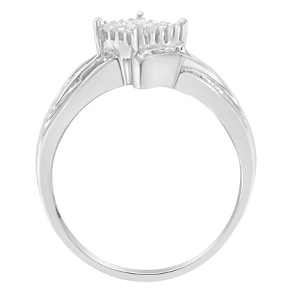 White metal ring with a cluster of white gemstones in a prong setting, viewed from the side angle.