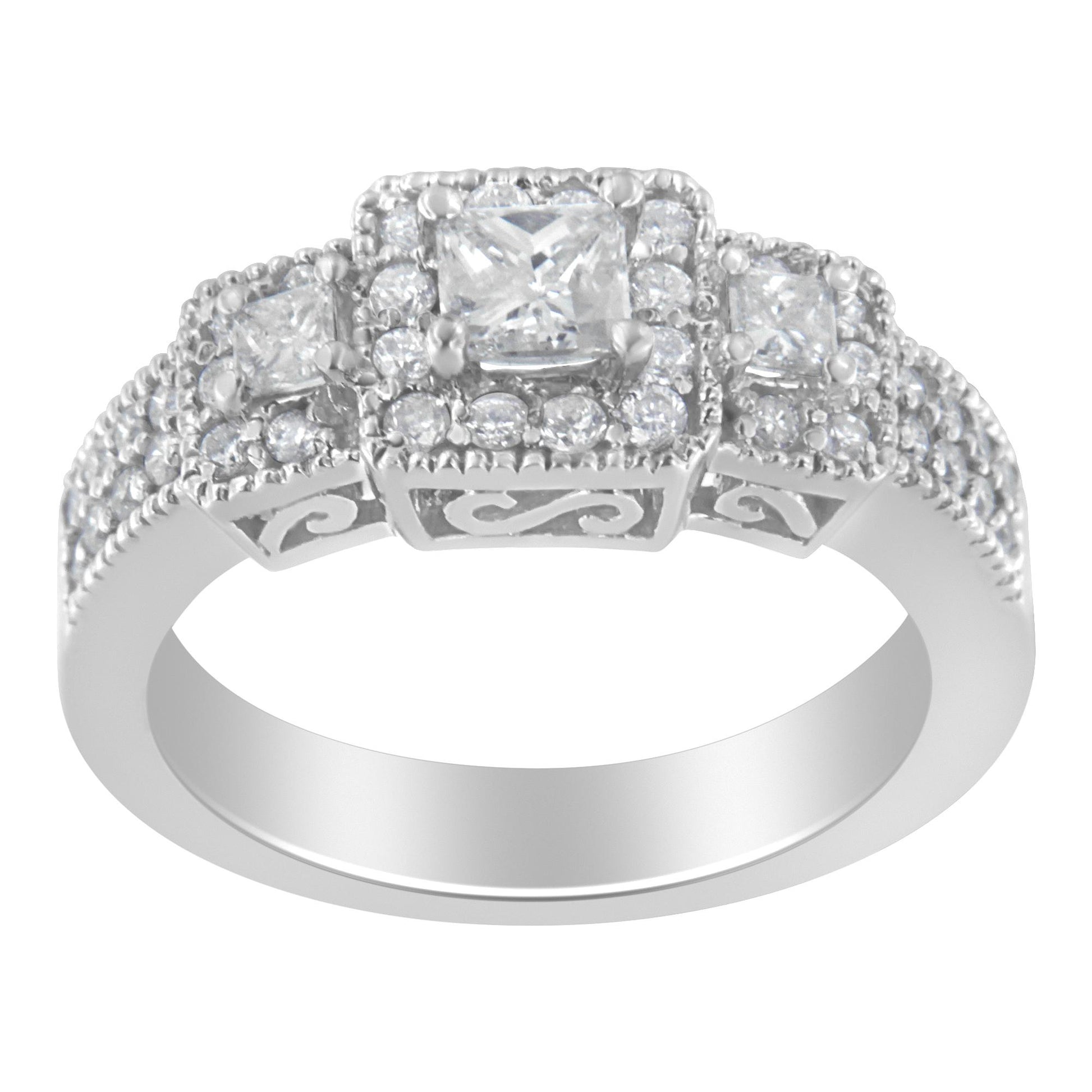 White metal ring with a three-stone setting featuring princess-shaped and round white gemstones, viewed from the front angle.