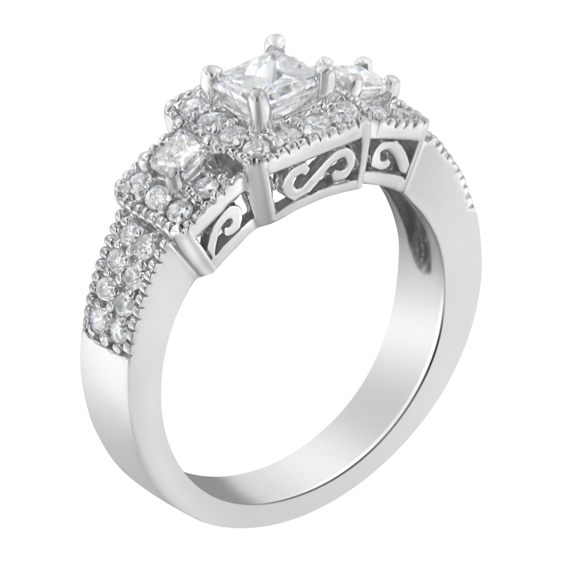 White metal ring with a central princess-shaped gemstone flanked by two smaller princess-shaped gemstones and multiple round gemstones set along the band, shown at a slightly angled top-down view.