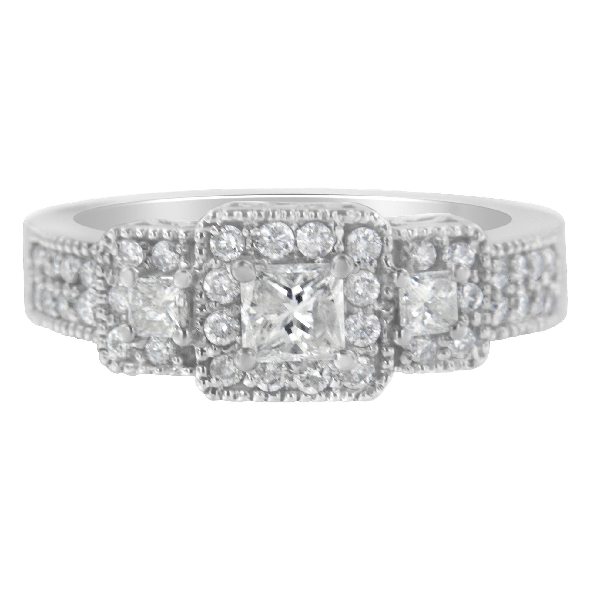 Front angle of a white ring featuring one central princess-shaped gemstone, flanked by two smaller princess-shaped gemstones, all surrounded by multiple round white gemstones in prong settings.