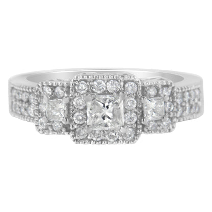 Front angle of a white ring featuring one central princess-shaped gemstone, flanked by two smaller princess-shaped gemstones, all surrounded by multiple round white gemstones in prong settings.