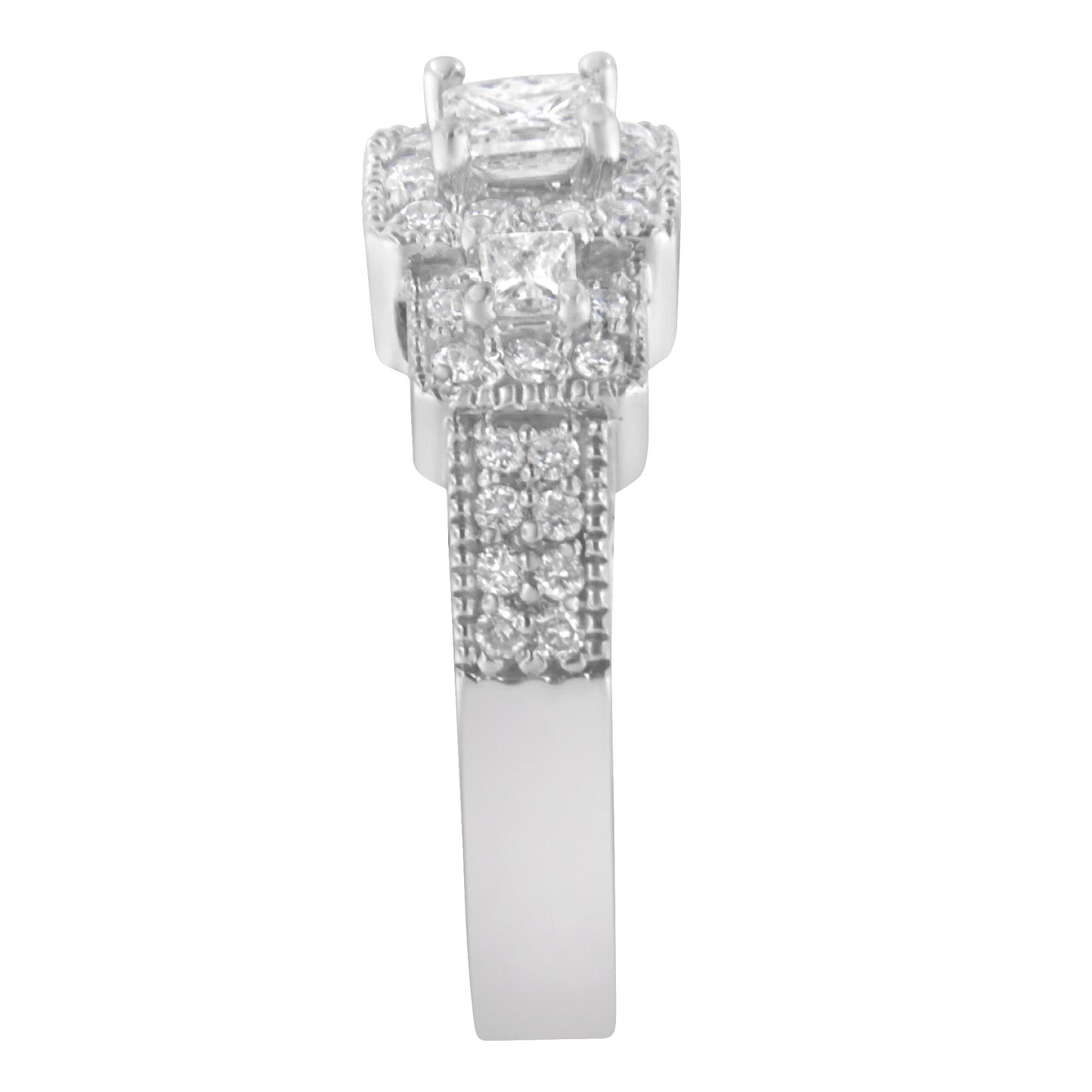 Front view of a white metal ring featuring one princess shape white gemstone in prong setting at the top, two princess shape white gemstones in prong setting below it, and multiple small round shape white gemstones in prong settings along the band.