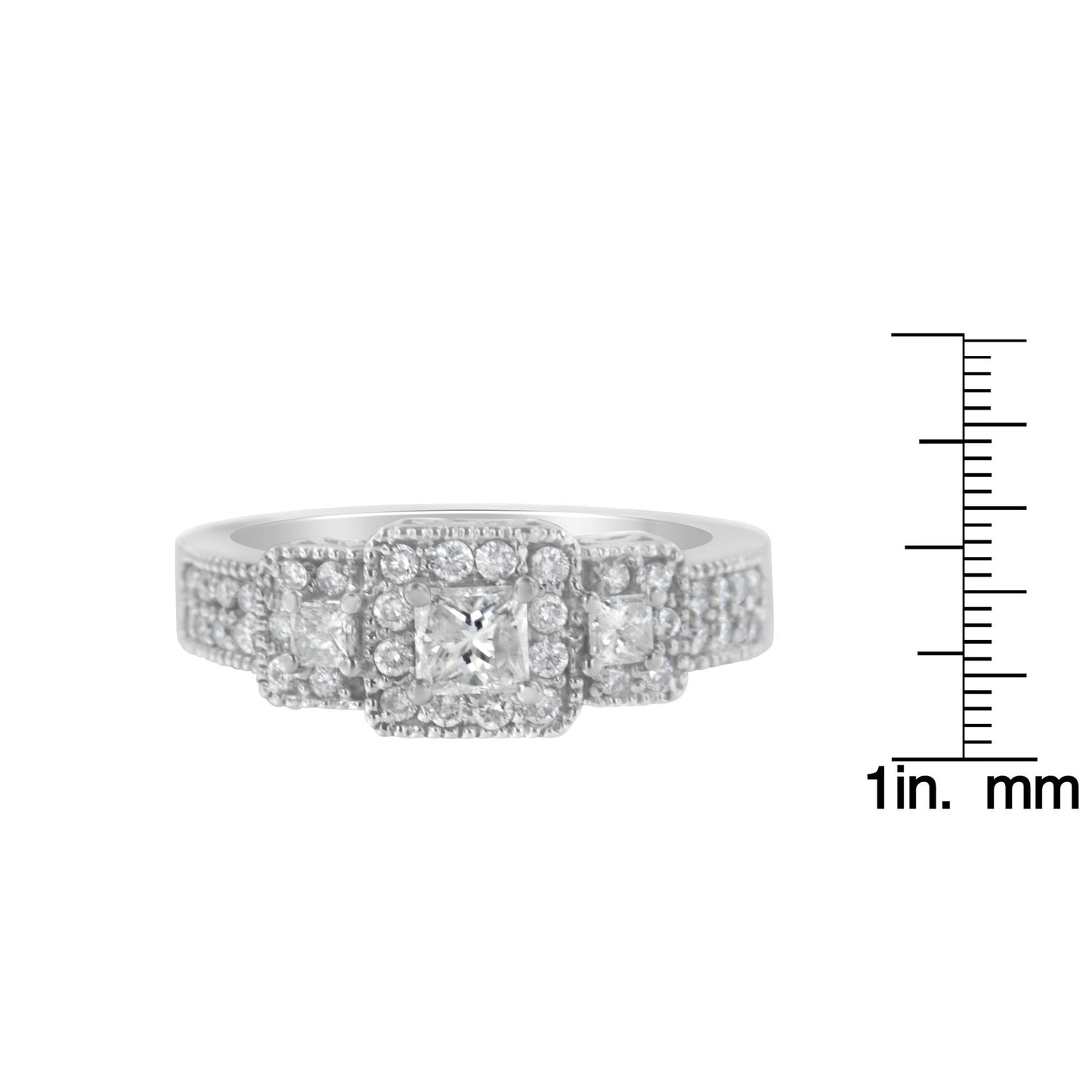 Front view of a white metal ring with three princess shape white gemstones in prong settings, surrounded by multiple small round white gemstones in prong settings, shown next to a ruler for size reference.