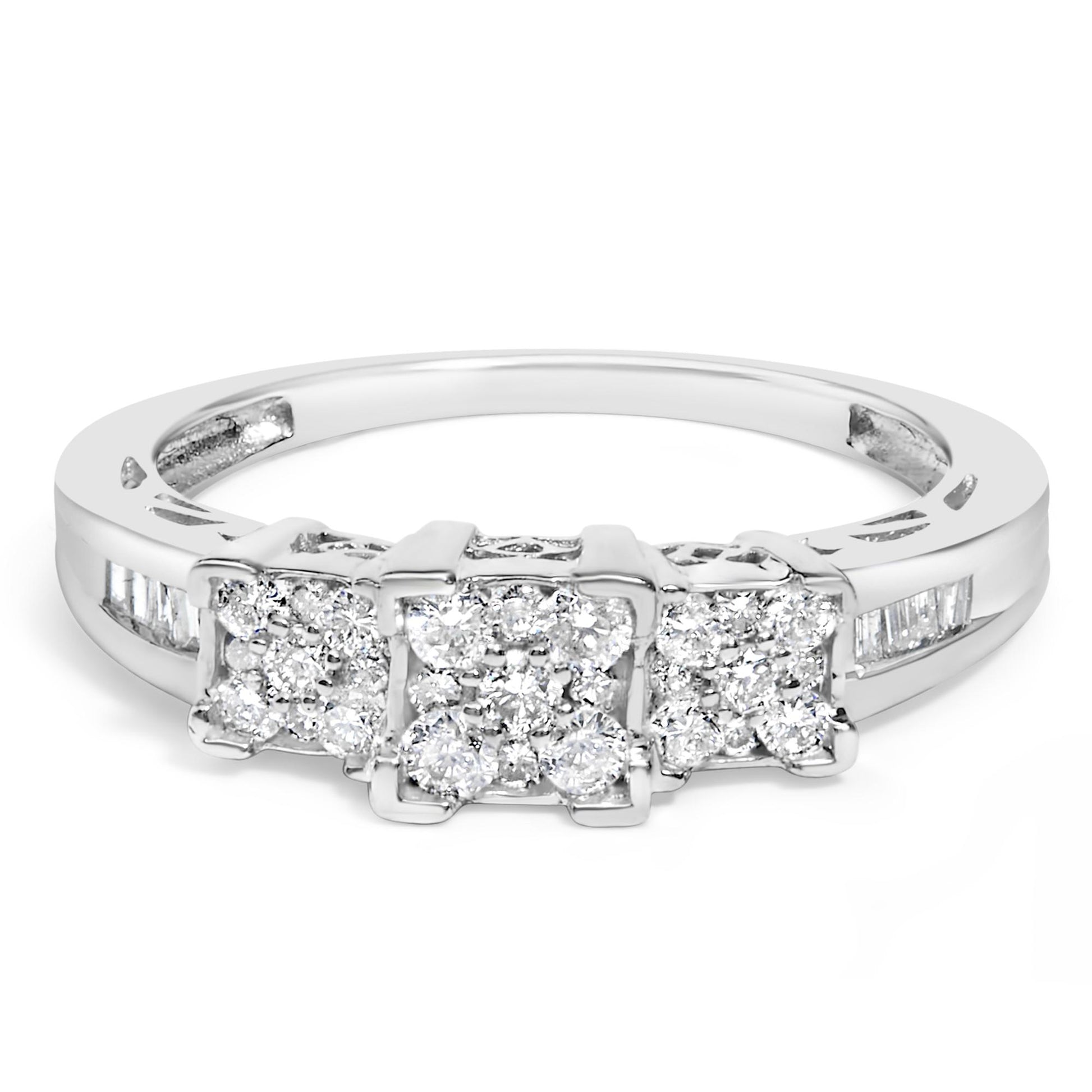 Close-up front angle of a white metal ring with three square clusters of round pave-set white gemstones and baguette-shaped gemstones channel-set along the band.