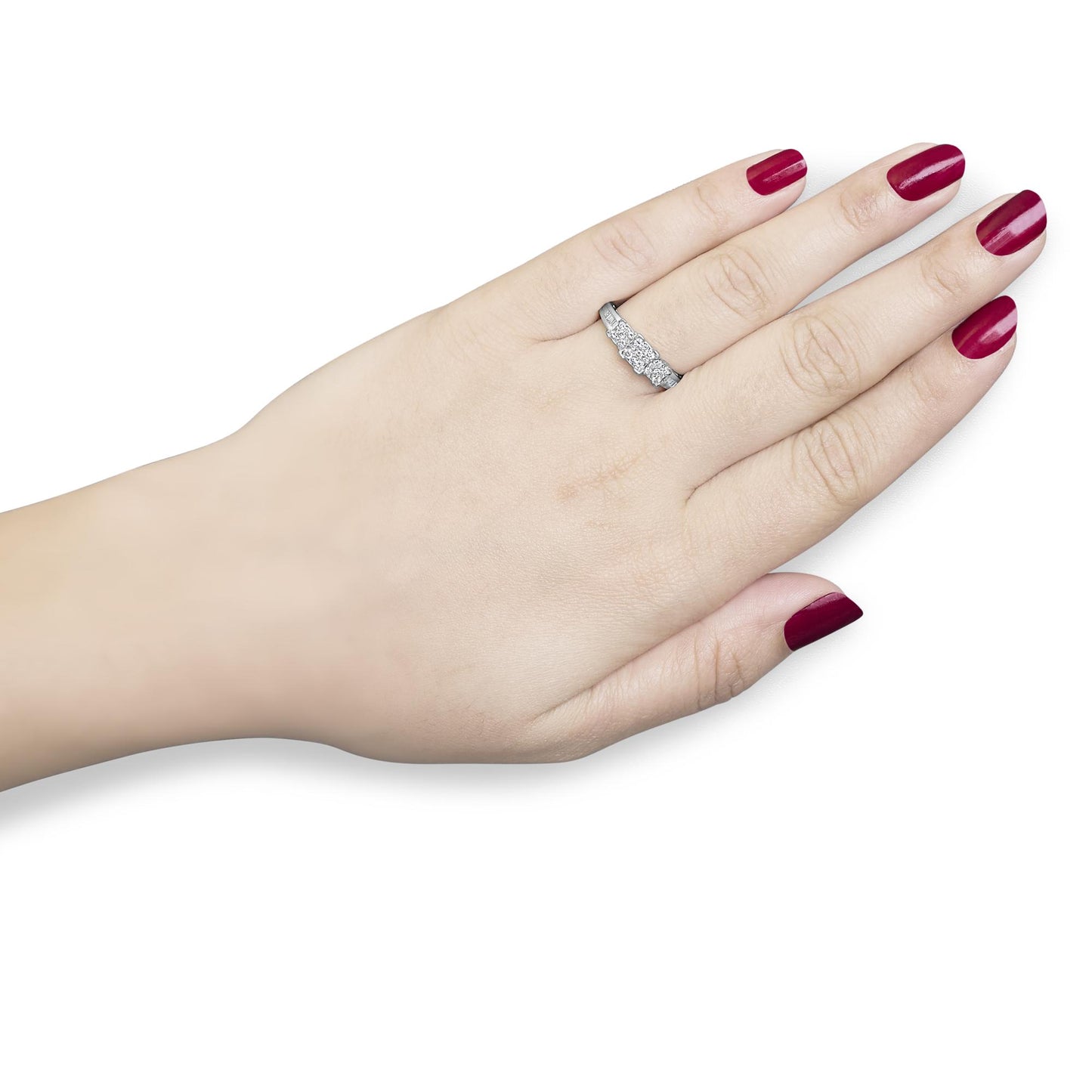 Close-up front angle of a white metal ring on a model's finger, featuring round and baguette shaped white gemstones in pave and channel settings.
