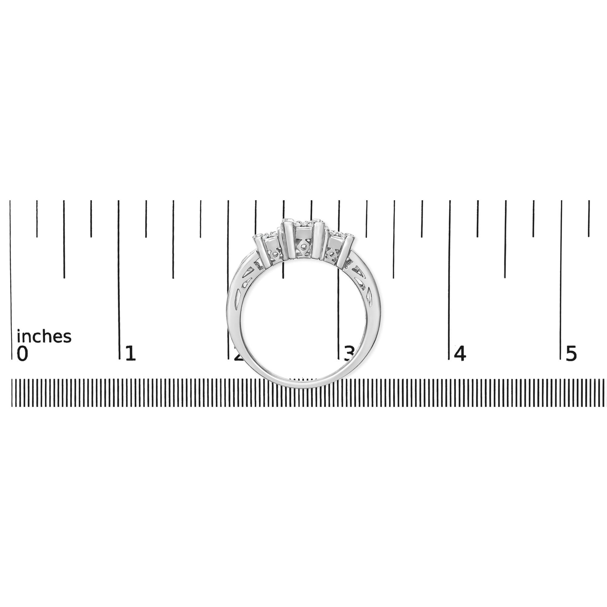 White metal ring with round and baguette shaped white gemstones in pave and channel settings, shown from the side on a ruler for size reference.