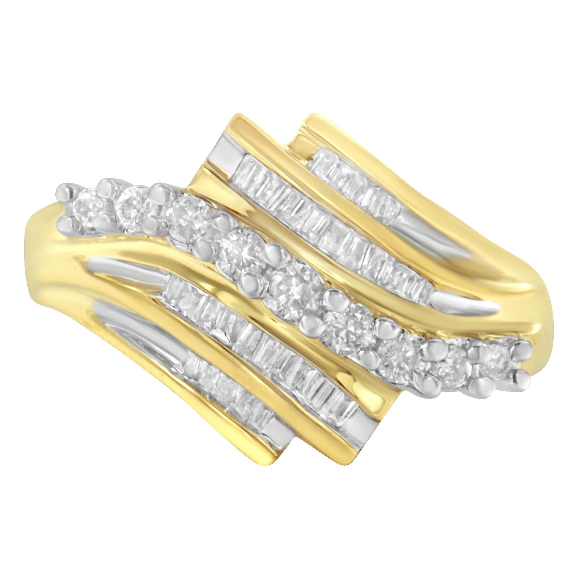 Close-up front angle view of a yellow ring with alternating rows of round and baguette-shaped white gemstones in prong and channel settings.