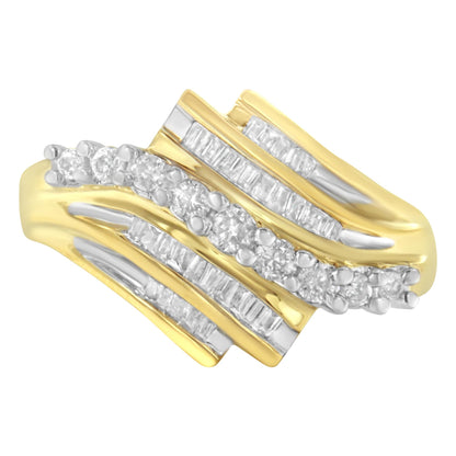Close-up front angle view of a yellow ring with alternating rows of round and baguette-shaped white gemstones in prong and channel settings.