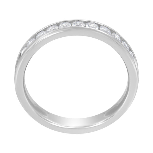 Top-down view of a white ring with a channel setting of round white gemstones encircling half the band.