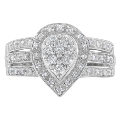 Front-facing view of a white ring with a pear-shaped cluster of round white gemstones surrounded by a halo of smaller round white gemstones and a triple band adorned with small round white gemstones.