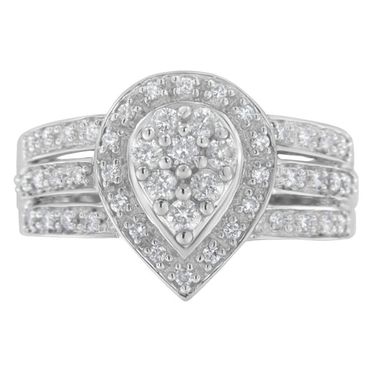 Front-facing view of a white ring with a pear-shaped cluster of round white gemstones surrounded by a halo of smaller round white gemstones and a triple band adorned with small round white gemstones.