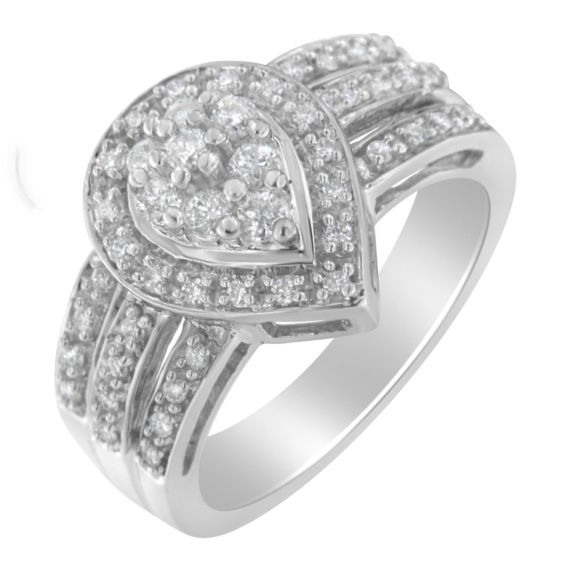 Angled close-up of a white ring featuring a heart-shaped cluster of round white gemstones in a pave setting on top, with additional pave-set round white gemstones adorning the band.