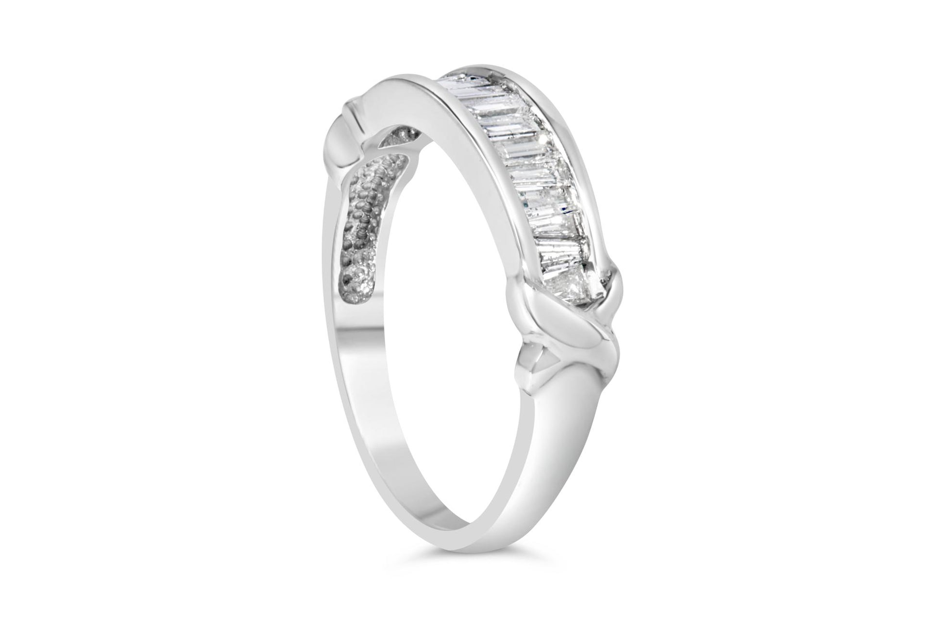 White metal ring with channel-set baguette-shaped white gemstones, shown at an angled side view.