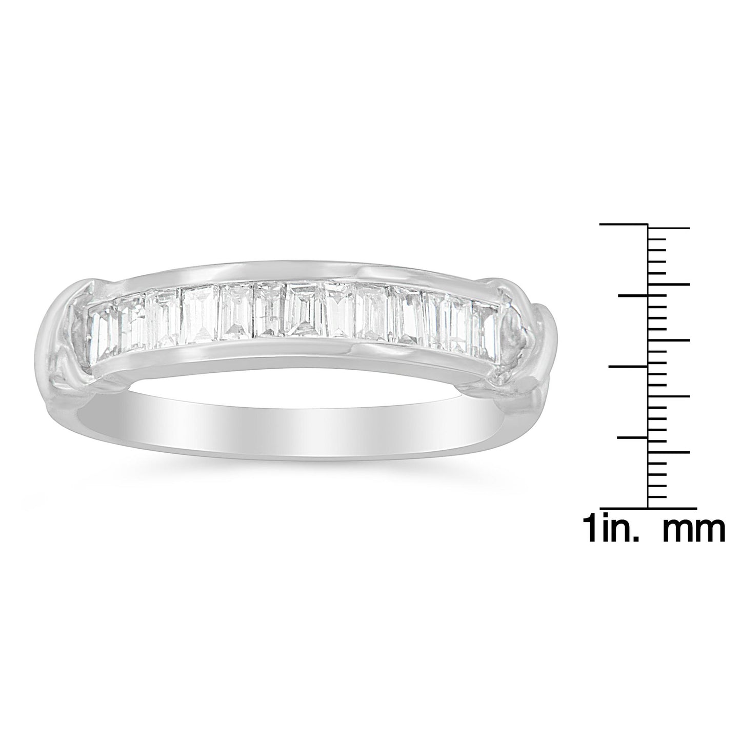 White metal ring with a row of baguette-shaped white gemstones in a channel setting, shown from a side angle, placed next to a ruler for size reference.