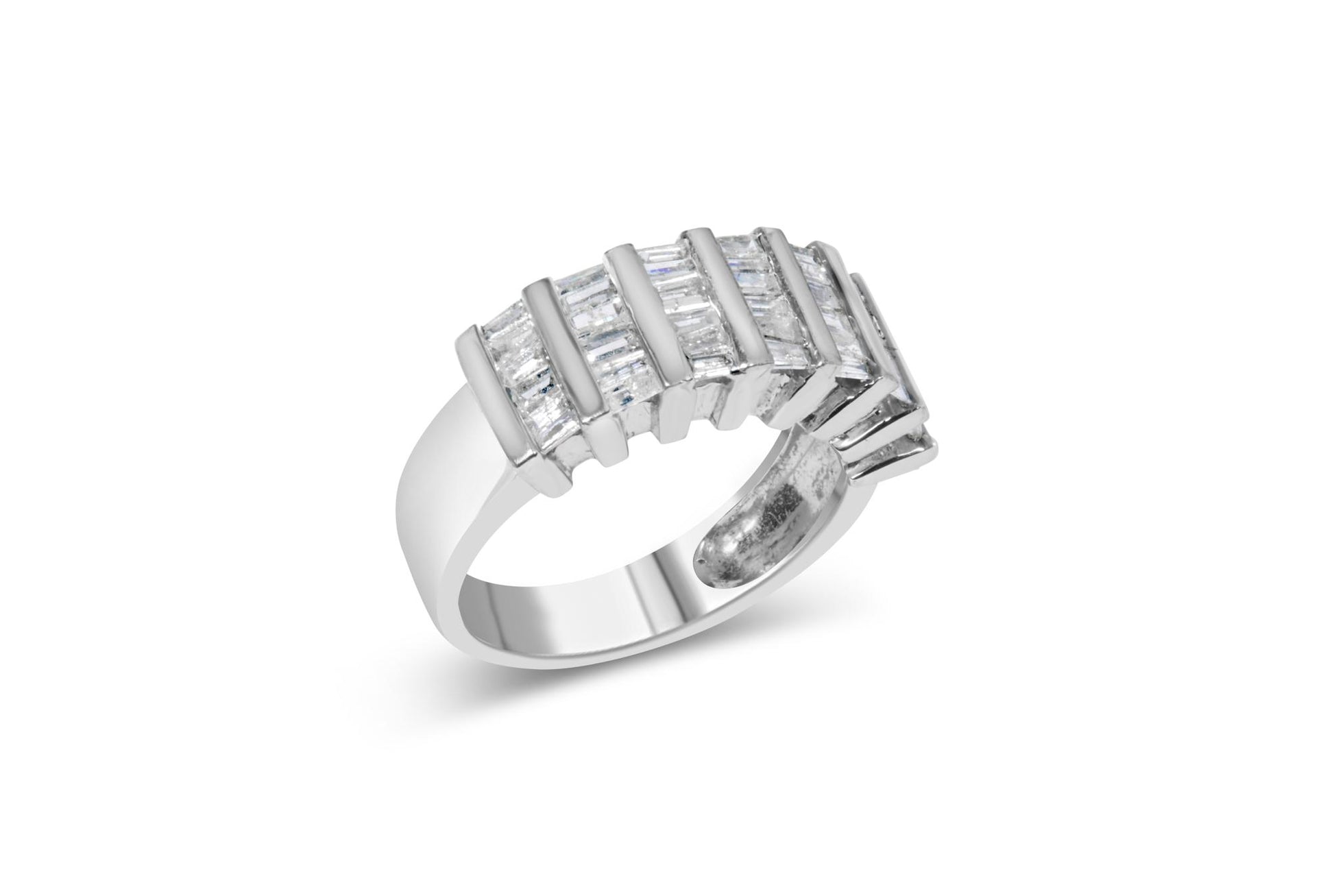 White metal ring with an open design featuring rows of channel-set baguette-shaped white gemstones, shown at a slight angle.