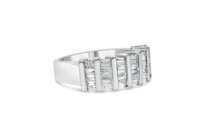 White metal ring with rows of baguette-shaped white gemstones in a channel setting, shown at an angled side view.