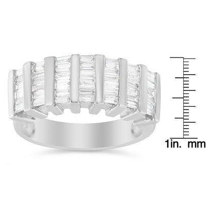 White metal ring with multiple rows of vertically set baguette-shaped white gemstones in a channel setting, shown from a front angle, placed next to a ruler for size reference.