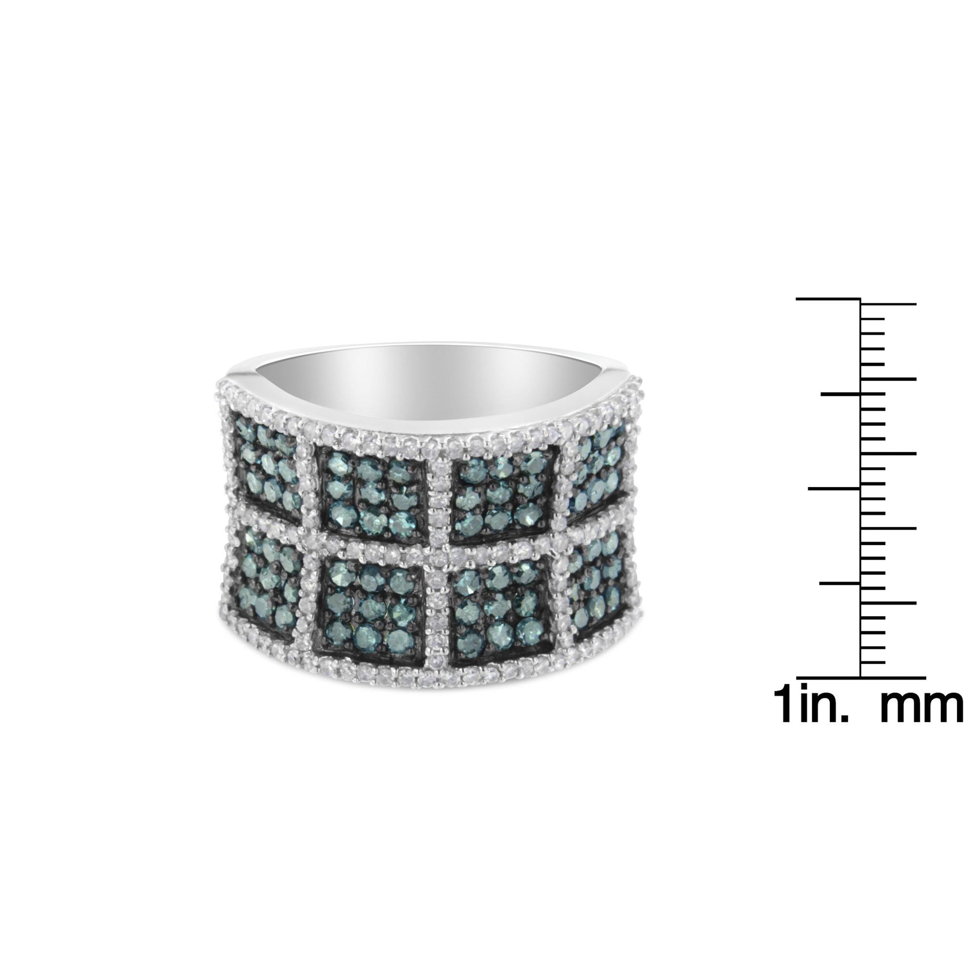 White metal ring with a wide band featuring square sections of blue gemstones bordered by rows of white gemstones, shown at a slight angle with a ruler for size reference.