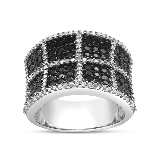 Front angled view of a wide white metal ring featuring a grid pattern with prong-set white round gemstones outlining pave-set black round gemstones.