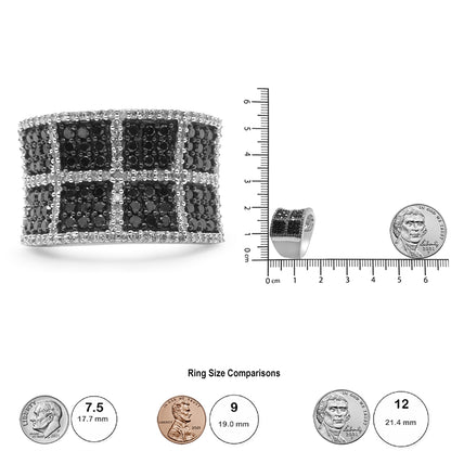 White metal ring with black and white round gemstones in prong and pave settings in a grid pattern, shown from a front angle on a ruler for size reference.