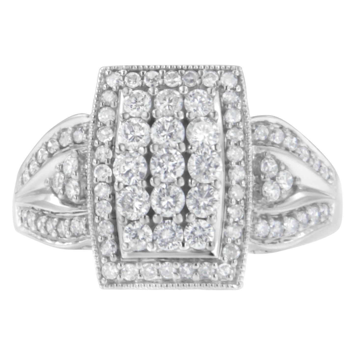 Top-down close-up of a white ring with a rectangular cluster of round white gemstones in a pave setting and additional gemstones on the band.