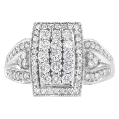 Top-down close-up of a white ring with a rectangular cluster of round white gemstones in a pave setting and additional gemstones on the band.