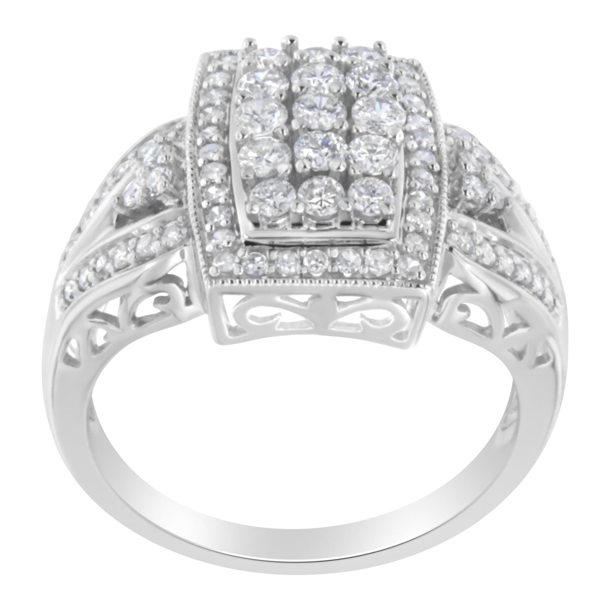 Front angle view of a white metal ring with multiple round white gemstones in pave setting on the top and along the band, featuring intricate cut-out details on the sides.