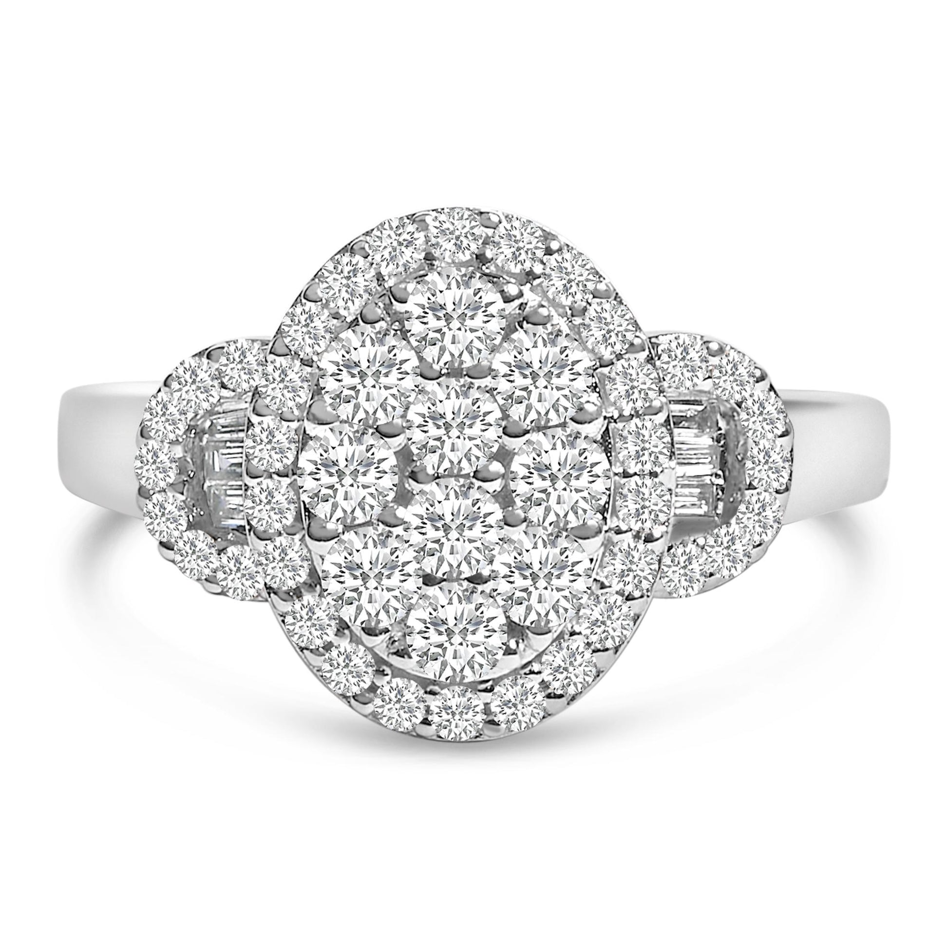 Front angle view of a white metal ring with clusters of round white gemstones in prong settings and baguette white gemstones in channel settings.