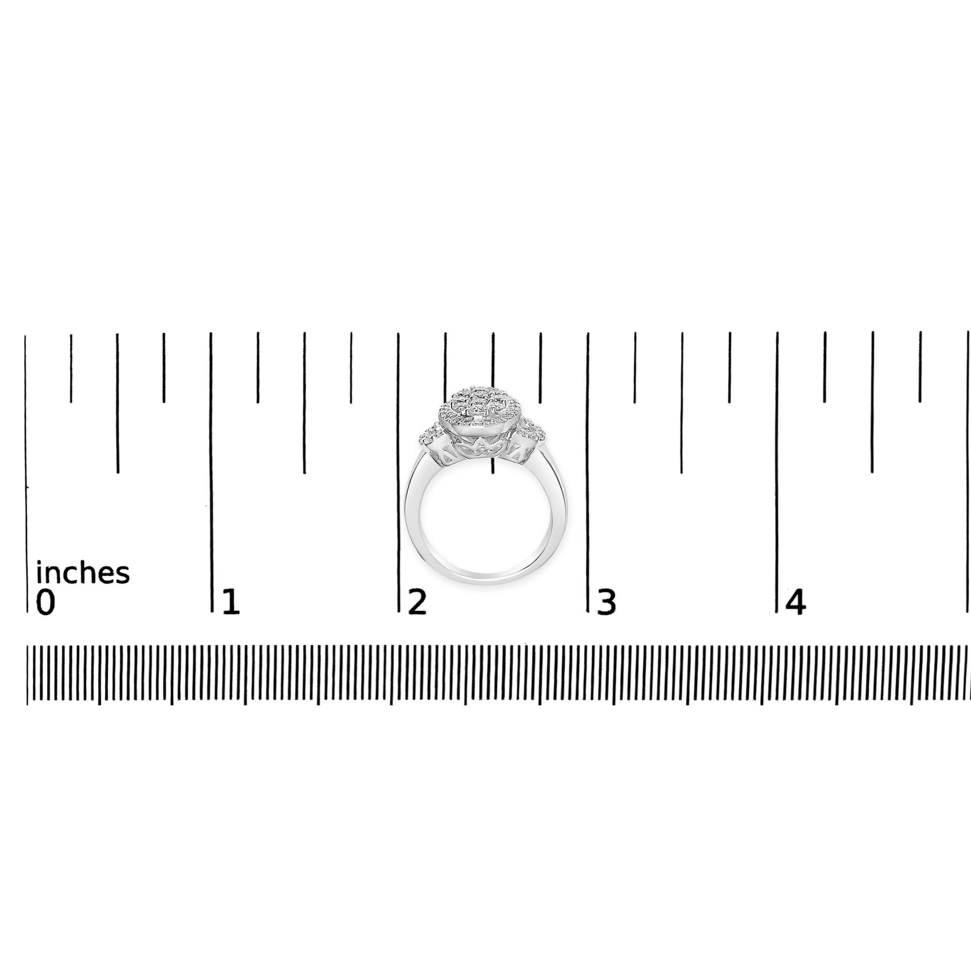 White metal ring with round and baguette shaped white gemstones in prong and channel settings, shown from front on a ruler for size reference.