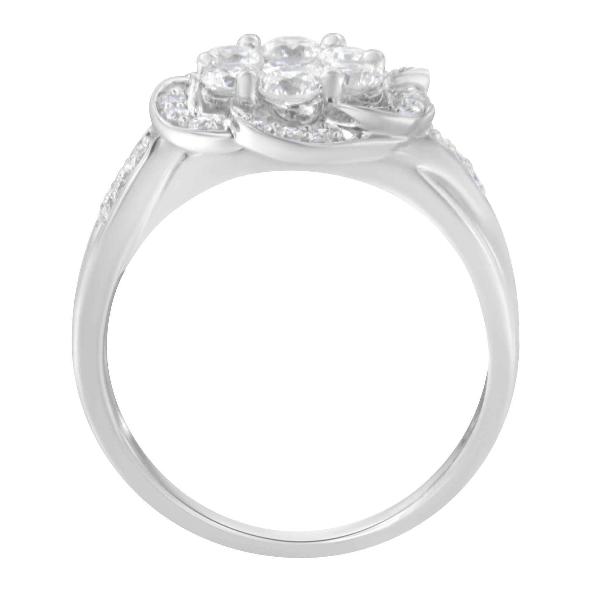 White metal ring shown from the side angle featuring multiple prong-set round white gemstones on the top and along the band.