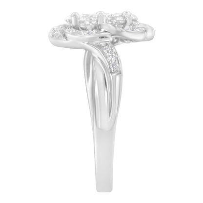 Side view of a white metal ring with a split band featuring multiple round white gemstones in prong settings on top and along the sides.