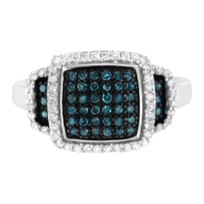 Top-front angle view of a white metal ring featuring a large square cluster of blue gemstones surrounded by pavé-set white gemstones, with additional blue and white gemstone clusters on the shoulders.