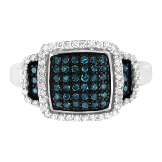 Top-front angle view of a white metal ring featuring a large square cluster of blue gemstones surrounded by pavé-set white gemstones, with additional blue and white gemstone clusters on the shoulders.