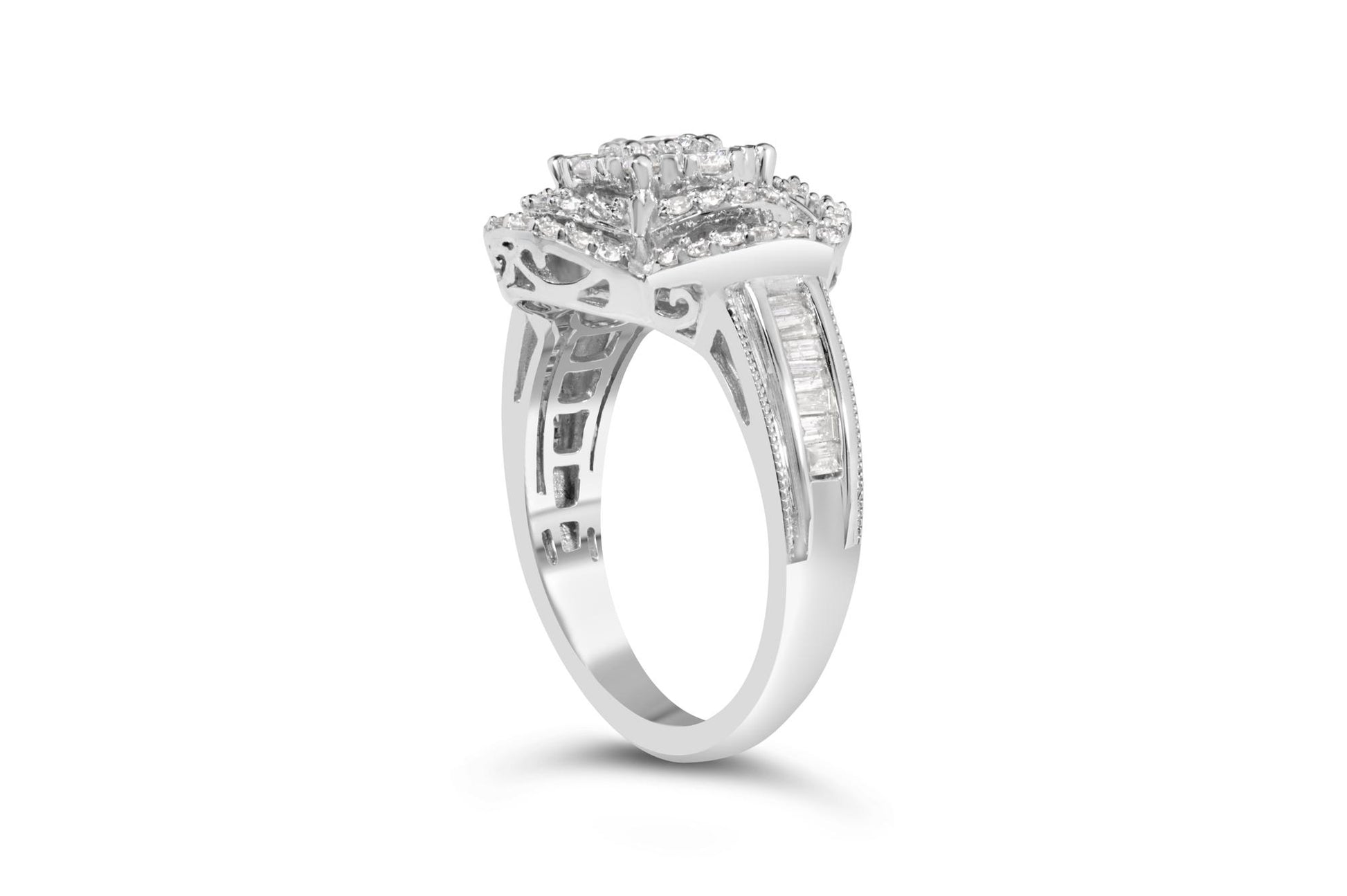 White metal ring with a cluster of round white gemstones in prong settings on top, accented by baguette white gemstones in channel settings along the band, shown from a side angle.