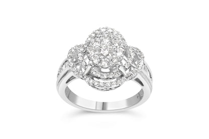 Front-facing close-up of a white metal ring featuring an oval cluster of round white gemstones in prong settings at the center, surrounded by three concentric oval loops also set with small round white gemstones. The band has channel-set baguette-shaped white gemstones and additional round white gemstones in prong settings along the sides. The ring is shown on a white background.