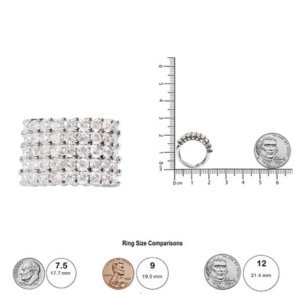 White ring with multiple rows of round white gemstones in prong settings, shown from front and side angles on a scale with coins for size comparison.
