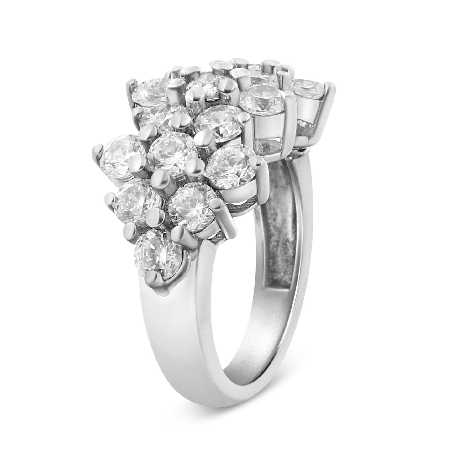 White metal ring with cluster of round white gemstones in prong settings, photographed at an angled view.