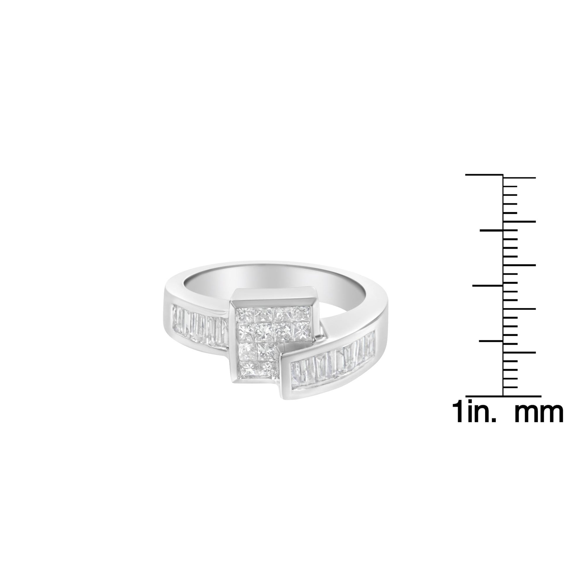 White metal ring with channel set princess and baguette shape white gemstones viewed from a slight angle, shown next to a ruler for size reference.