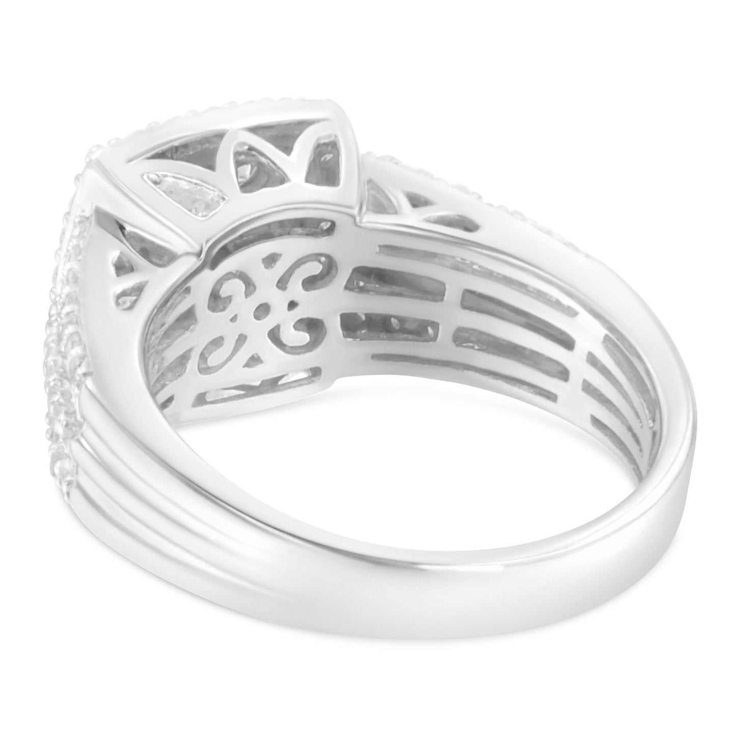 Close-up angled side view of a white metal ring featuring intricate cut-out designs inside the band and decorated with multiple round and baguette-shaped white gemstones.