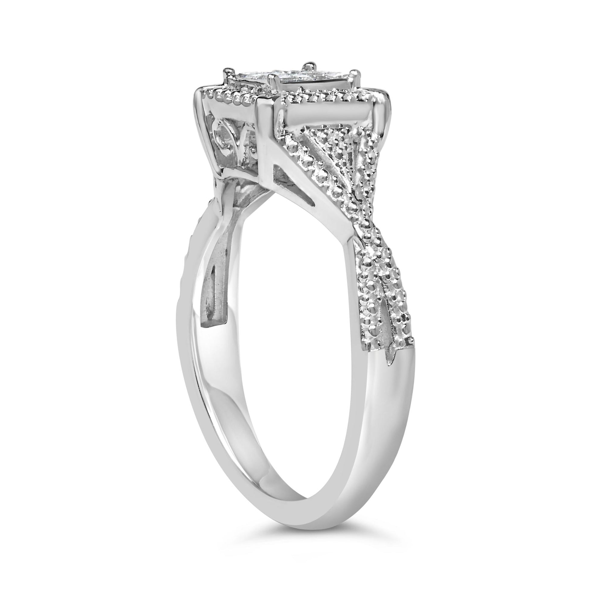 White metal ring with a princess shape centerpiece and small white gemstones in an invisible setting, shown from a side angle.