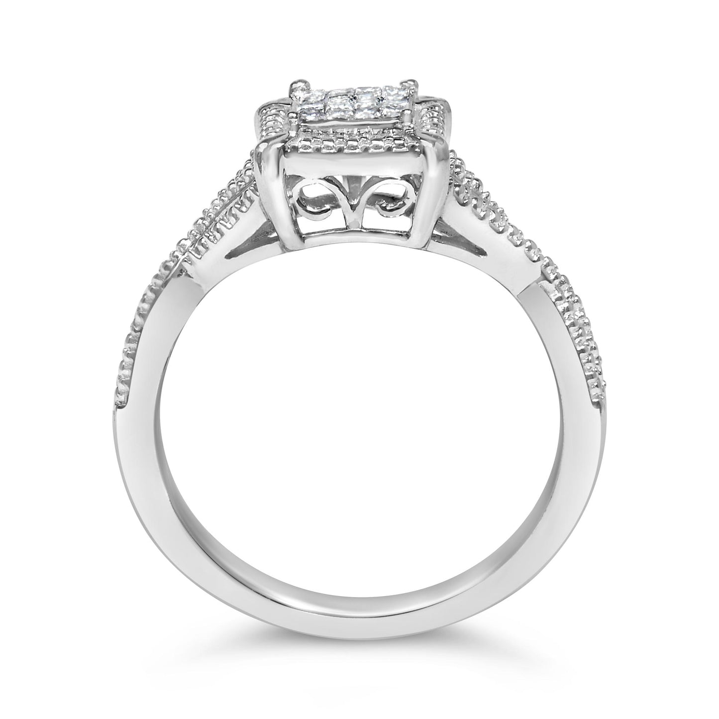 Front-facing close-up of a white metal ring featuring princess-shaped white gemstones set invisibly on the top and along the band, with decorative scrollwork beneath the stones.