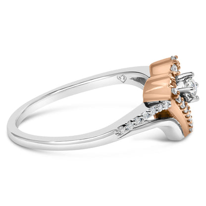 Side angled view of a two-tone ring with white and rose metal featuring a central white gemstone in prong setting surrounded by smaller white gemstones in prong settings along the band.