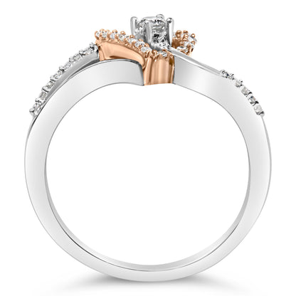 Close-up side view of a two-tone ring with a white metal band and rose-colored metal accents, featuring multiple small white gemstones along the band and a single larger white gemstone set at the top.