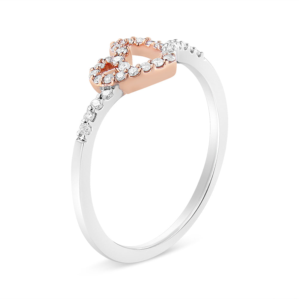 Close-up front angled view of a rose and white metal ring featuring a rose metal heart shape adorned with small round white gemstones in prong setting, with additional small round white gemstones set along the white metal band.