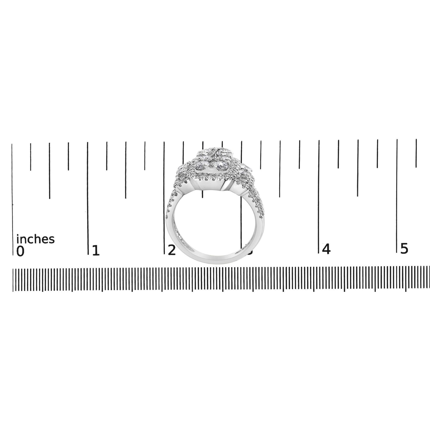 White metal ring with multiple prong-set white round gemstones viewed from the front, positioned on a ruler for size reference.