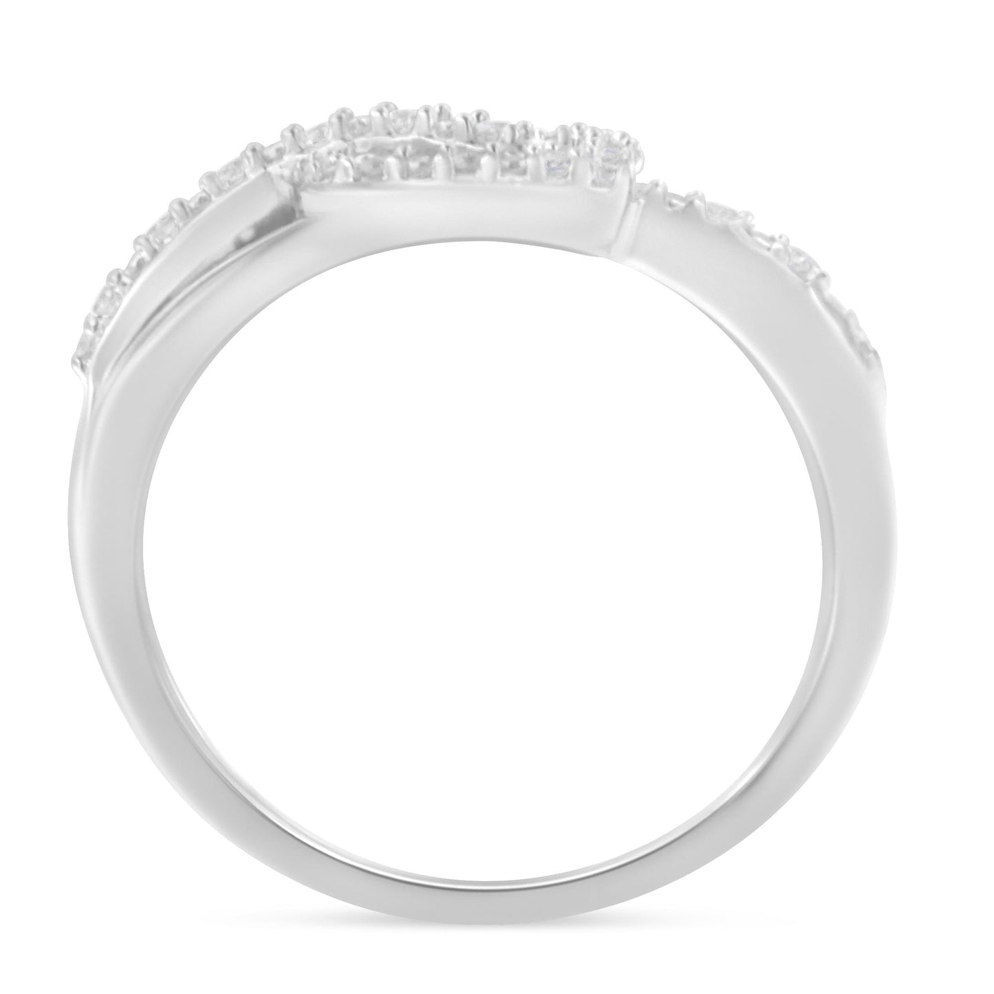 White metal ring with round white gemstones in prong settings, shown in a side angle view.