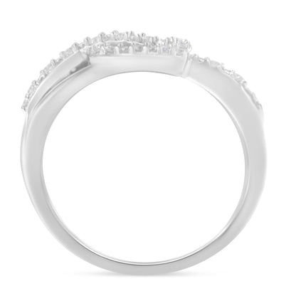 White metal ring with round white gemstones in prong settings, shown in a side angle view.