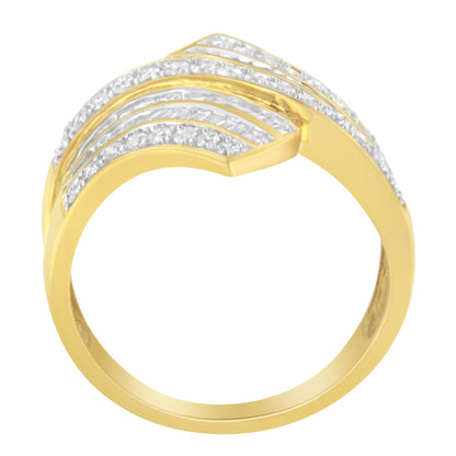 Yellow metal ring with rows of white round gemstones in pave setting and white baguette gemstones in channel setting, shown from an angled top view.